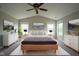 Vaulted ceiling bedroom with a ceiling fan, three windows, and minimalist decor at 12382 Cool Winds Way, Fishers, IN 46037