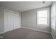 Cozy bedroom with neutral carpet, closet space, and a bright window for natural light at 12382 Cool Winds Way, Fishers, IN 46037