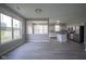 An open-concept dining room with backyard view, flowing into the kitchen area at 12382 Cool Winds Way, Fishers, IN 46037