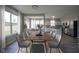 An open-concept dining room features backyard views, with access to the kitchen at 12382 Cool Winds Way, Fishers, IN 46037