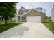 Charming two-story brick home featuring a two-car garage and well-manicured landscaping at 12382 Cool Winds Way, Fishers, IN 46037