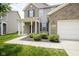 Charming home with a brick and siding facade, well-manicured landscaping, and attached garage at 12382 Cool Winds Way, Fishers, IN 46037