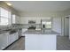 Bright kitchen featuring white cabinets, stainless appliances, and a marble island at 12382 Cool Winds Way, Fishers, IN 46037