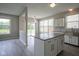 Spacious kitchen featuring an island with marble countertops, white cabinets, and sliding glass doors at 12382 Cool Winds Way, Fishers, IN 46037