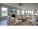 Bright living room features a fireplace, a ceiling fan, and ample natural light at 12382 Cool Winds Way, Fishers, IN 46037