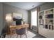 Cozy home office with a work desk, stylish bookshelf, and soft lighting, perfect for productivity at 12382 Cool Winds Way, Fishers, IN 46037