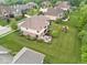 Backyard aerial view featuring a patio seating area, play set, and spacious lawn, perfect for outdoor activities and entertainment at 13429 Boxelder Ct, Carmel, IN 46074