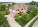 An aerial view of a home with a manicured lawn, a driveway leading to a garage, and mature trees at 13429 Boxelder Ct, Carmel, IN 46074