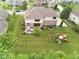 Aerial view of a backyard with a patio, play set, and mature trees creating a private outdoor living space at 13429 Boxelder Ct, Carmel, IN 46074