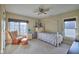 Cozy bedroom featuring a rocking chair, ceiling fan and a four-poster bed, flooded with natural light at 13429 Boxelder Ct, Carmel, IN 46074
