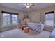 Bedroom featuring a window with a backyard view and chair and ottoman at 13429 Boxelder Ct, Carmel, IN 46074