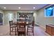 A dining area adjacent to a bar featuring a wood table and chairs and a tile floor at 13429 Boxelder Ct, Carmel, IN 46074