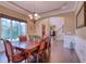 Bright dining room with a large window, chandelier, and wood floors at 13429 Boxelder Ct, Carmel, IN 46074