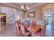 Formal dining room featuring a wooden table, decorative lighting, and views of the staircase at 13429 Boxelder Ct, Carmel, IN 46074
