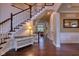 Gorgeous staircase and hardwood floors, as well as an accent table at 13429 Boxelder Ct, Carmel, IN 46074