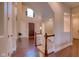 Lovely foyer featuring hardwood floors, a staircase, and a bright window above the front door at 13429 Boxelder Ct, Carmel, IN 46074