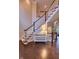 Grand staircase featuring hardwood floors and an accent table at 13429 Boxelder Ct, Carmel, IN 46074