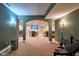 An arched entryway shows a gym, dining area, and bar in a home at 13429 Boxelder Ct, Carmel, IN 46074
