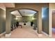 An arched entryway leading to a gym featuring work out equipment and ample space for activities at 13429 Boxelder Ct, Carmel, IN 46074