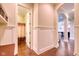 Hallway with wainscoting leading to bathroom and living room at 13429 Boxelder Ct, Carmel, IN 46074