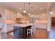 Spacious kitchen boasts an island, ample counter space, custom cabinetry, and stainless steel appliances at 13429 Boxelder Ct, Carmel, IN 46074