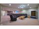 Open concept living room featuring black leather furniture and access to the bar and bathroom at 13429 Boxelder Ct, Carmel, IN 46074