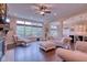 Open-concept living room featuring hardwood floors, fireplace, and large windows for plenty of natural light at 13429 Boxelder Ct, Carmel, IN 46074