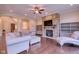 Beautiful living room featuring a stone fireplace, hardwood floors, and crown molding at 13429 Boxelder Ct, Carmel, IN 46074