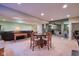 Spacious carpeted living room features a wood table and chairs, adjacent to a leather sofa at 13429 Boxelder Ct, Carmel, IN 46074