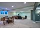 A spacious living room with hardwood table and chairs and black leather furniture at 13429 Boxelder Ct, Carmel, IN 46074
