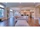Bright living room with hardwood floors and an open layout connecting to the dining area and kitchen at 13429 Boxelder Ct, Carmel, IN 46074