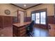 Office featuring wood flooring, wood paneling, and a large window at 13429 Boxelder Ct, Carmel, IN 46074