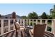 Decked balcony offers views of the neighborhood's lush greenery and nearby houses at 1510 Dominion Dr, Zionsville, IN 46077