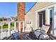Exterior balcony view, featuring a brick chimney and plush outdoor seating at 1510 Dominion Dr, Zionsville, IN 46077