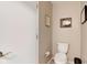 Clean half bath featuring a toilet and minimalist decor at 1510 Dominion Dr, Zionsville, IN 46077