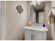 Elegant half bath features a vanity with marble countertop and decorative mirror at 1510 Dominion Dr, Zionsville, IN 46077