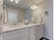 Bathroom with double sink vanity with a white marble countertop and sleek chrome fixtures at 1510 Dominion Dr, Zionsville, IN 46077