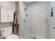 Modern bathroom with a glass-enclosed shower featuring white subway tile, and a white toilet at 1510 Dominion Dr, Zionsville, IN 46077