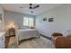 Bright bedroom with a ceiling fan, neutral walls, stylish rug, and a large window at 1510 Dominion Dr, Zionsville, IN 46077