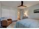 Inviting bedroom features a ceiling fan, neutral paint, a stylish area rug, and an ensuite bathroom at 1510 Dominion Dr, Zionsville, IN 46077
