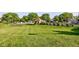Expansive green lawn within a community featuring a pool and tennis courts at 1510 Dominion Dr, Zionsville, IN 46077