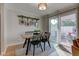 Bright dining area with a wooden table and chairs, leading to an outdoor patio at 1510 Dominion Dr, Zionsville, IN 46077