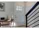 An inviting open foyer with a modern steel railing and a glimpse of the outdoors at 1510 Dominion Dr, Zionsville, IN 46077