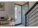 An inviting open foyer with a modern steel railing and a glimpse of the outdoors at 1510 Dominion Dr, Zionsville, IN 46077