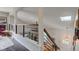 Bright hallway features modern railing, a skylight, and staircase leading to the home's entryway at 1510 Dominion Dr, Zionsville, IN 46077