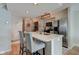 Modern kitchen island with bar seating and stainless steel appliances at 1510 Dominion Dr, Zionsville, IN 46077