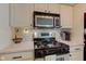 Bright kitchen features stainless steel appliances, white cabinets, and stylish countertops at 1510 Dominion Dr, Zionsville, IN 46077