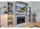 Cozy living room featuring a fireplace with built-in shelving and a large screen television at 1510 Dominion Dr, Zionsville, IN 46077
