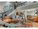 Spacious living room with vaulted ceilings, a staircase, and leather furniture at 1510 Dominion Dr, Zionsville, IN 46077