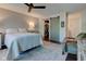Bright main bedroom with a ceiling fan, neutral walls, a stylish rug, and a convenient walk-in closet at 1510 Dominion Dr, Zionsville, IN 46077